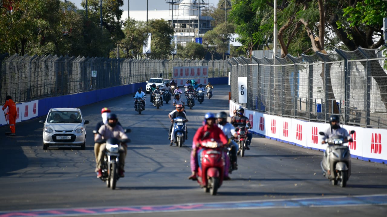 Warga lokal melintasi sirkuit Formula E India yang seharusnya steril. (Twitter/@RVKRao2)