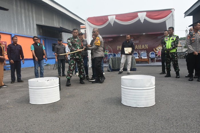 Kapolres Mojokerto dan Dandim membakar kertas suara yang rusak di halaman gudang logistik KPU.(blok-a.com/Syahrul Wijaya)
