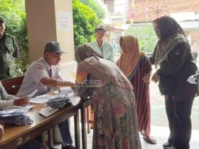 Ibu Absah mendatangi TPS 03 kelurahan Bedilan setelah dijemput anggota PPS di rumahnya. (blok-a.com/Ivan)