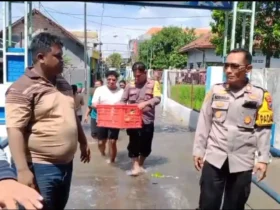 Anggota Polsek Jombang berikan bantuan kepada korban bencana banjir.(blok-a.com/Syahrul Wijaya)