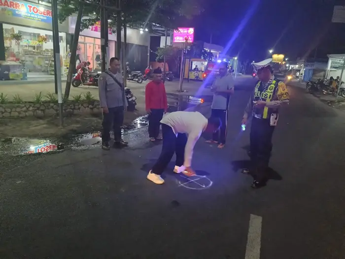 Petugas kepolisian saat olah TKP lakalantas di simpang empat menuju Ponpes Darussalam Blokagung, Kecamatan Tegalsari, Kamis (9/1/2025).(blok-a.com/Kuryanto)