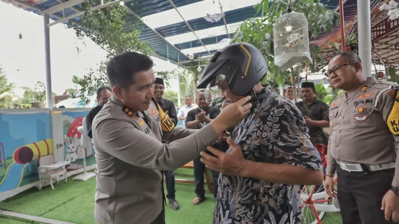 FOTO : Kapolres Blitar AKBP Arif Fazlurrahman memasangkan helm kepada tokoh perguruan silat di Kabupaten Blitar. (blok-a.com/Fajar)