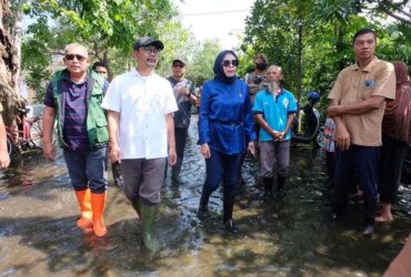 Editan Pewarta : Fahmi Rosyidi Judul : Pemkab Sidoarjo Beri Bantuan Sembako Korban Banjir Sidoarjo, Blok-a.com - Memasuki hari pertama bulan suci Ramadan, Wakil Bupati Sidoarjo, Mimik Idayana, mengunjungi warga terdampak banjir di tiga lokasi berbeda, yakni Desa Balongdowo, Desa Balonggabus, Kecamatan Candi, dan Perum Bumi Citra Fajar Golf (CFG) Kecamatan Sidoarjo. Dalam kunjungannya ini, Mimik Idayana bersama Forkopimda Sidoarjo menyalurkan bantuan sosial berupa sembako kepada warga terdampak banjir. Pemberian bantuan sembako ini bertujuan untuk meringankan beban bagi warga yang terkena musibah banjir. "Ada sekitar 500 warga dari 3 RT yang rumahnya terendam banjir kita berikan bantuan sembako," ujar Mimik Idayana, saat kunjungannya di CFG Sidoarjo, Sabtu (1/3/2025). Dia berharap warga lebih bersabar, karena musibah banjir yang terjadi akibat air laut meluap ini, Pemda masih terus berupaya menangani dengan menambah mesin pompa. Mimik meminta OPD terkait agar bergerak cepat menangani banjir yang sudah terjadi selama hampir sepekan ini. Salah satunya adalah pengiriman bantuan mobil pompa yang ditempatkan di fasum. "Untuk menjalankan mesin rumah pompa, kami juga menyediakan bantuan BBM solarnya," ujarnya. "Pemkab Sidoarjo akan terus berkoordinasi dengan semua pihak untuk mencari solusi jangka panjang. Tujuannya untuk mengantisipasi terulangnya bencana serupa di masa mendatang," tambahnya. Pihaknya akan melakukan evaluasi menyeluruh terkait penyebab banjir ini. Termasuk normalisasi sungai dan saluran air yang tersumbat. Pihaknya juga mengimbau masyarakat agar tetap waspada di musim penghujan. Sementara itu Kepala PUBMSDA Sidoarjo, Dwi Eko Saptono, menyampaikan upaya Pemkab Sidoarjo adalah memberikan solusi dengan membuat long storage. Dengan long storage itu akan bisa membantu mengurangi debit air. Sedangkan untuk upaya lain, pihaknya akan melakukan survei ketinggian sungai. Pemerintah Kabupaten Sidoarjo berkomitmen untuk terus memantau perkembangan situasi di lapangan dan memastikan semua warga yang terdampak mendapat bantuan yang memadai. Harapannya, masyarakat dapat segera pulih dari musibah ini dan kembali menjalani aktivitas seperti biasa. (Fah)