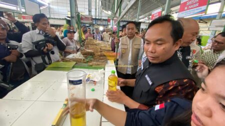 Wahyu Hidayat bersama Ali Muthohirin saat mengecek takaran MinyaKita di Pasar Bunul , Kota Malang, Kamis (13/3/2025) (blok-a.com / Yogga Ardiawan)