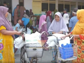 Warga masyarakat Desa Krembangan, Kecamatan Gudo, Kabupaten Jombang nampak ceria usai mendapatkan bantuan beras.(blok-a.com/Syahrul Wijaya)