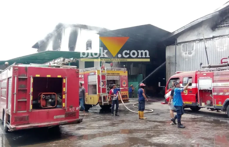 Petugas Pemadam Kebakaran terlihat sedang berusaha memadamkan api di Pabrik Sepatu yang terbakar.(foto: blok-a.com/Syahrul Wijaya)