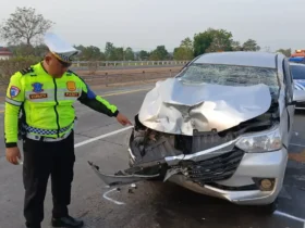 Panit PJR 3 Polda Jatim Ipda Siswanto di lokasi dan mobil Xenia yang ringsek bagian depannya usai alami kecelakaan. (Foto: PJR 3 Polda Jatim)