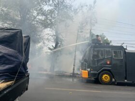 Teks: Polisi sedang memadamkan api menggunakan kendaraan Water Canon.(Foto: Istimewa)